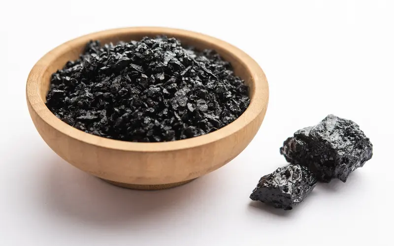 Shilajit in a wooden bowl on white counter
