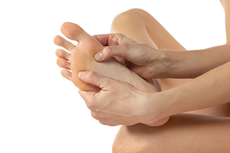 women's bare foot, foot care and self-massage