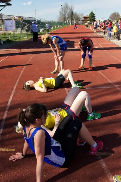 People tired and exhausted from heat, relaxing on sports track