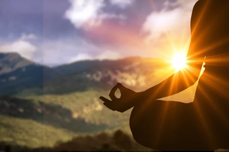 Meditating on mountain during sunset