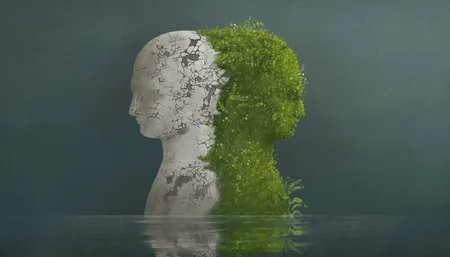 Surreal contrast emotions concept, broken human head sculpture and nature human head